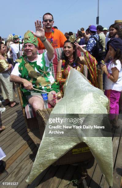 Brooklyn Borough President Marty Markowitz, dressed as King Neptune, waves to the crowd on the boardwalk during the annual Mermaid Parade in Coney...