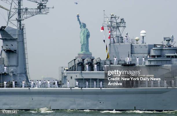 The Navy ship DeGrasse seems to have an extra passenger aboard - Miss Liberty - as it passes in front of the statue in New York Harbor. The ship will...