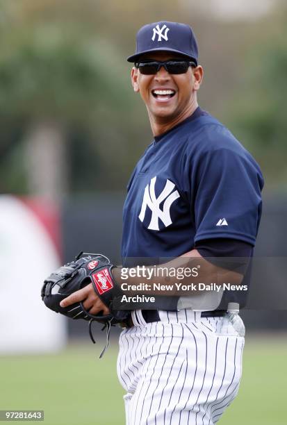 New York Yankees' Alex Rodriguez is all smiles as he fields grounders at third during the first full-squad workout of spring training at Legends...