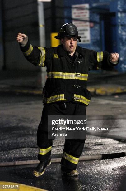 James Gandolfini dances in the street while dressed as a firefighter as he films a dream sequence from the upcoming movie "Romance & Cigarettes" on...