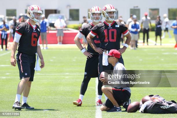 San Francisco 49ers Quarterback Jimmy Garoppolo , Jack Heneghan and C.J. Beathard watch as other teammates practice on June 12, 2018 at the SAP...