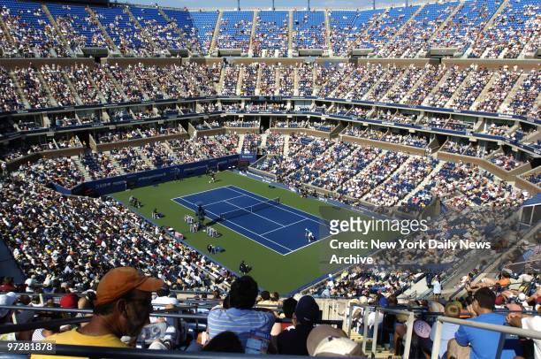 Crowd watches Andre Agassi of the United States take on Ivo Karlovic of Croatia during second round play in the U.S. Open at Arthur Ashe Stadium in...