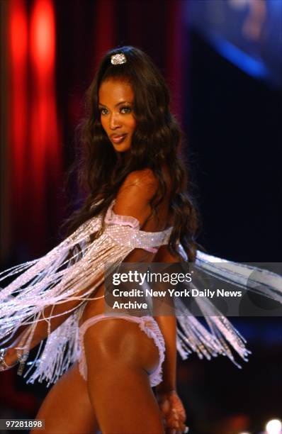Naomi Campbell twirls to show off a fringed strapless bra and satin bikini during the Victoria's Secret Fashion Show at the Lexington Avenue armory.