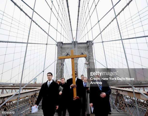 Former addick Frankie Simmonds carried cross as he leads procession across Brooklyn Bridge during "Way of the Cross" ceremony.,