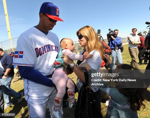 New York Yankees Alex Rodriguez passes his daughter Ella to his ex-wife Cynthia while daughter Natasha reaches out...The Dominican Republic baseball...