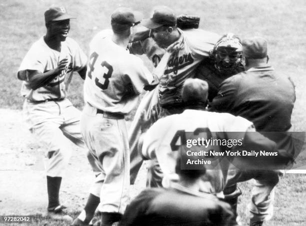 Brooklyn Dodgers' Johnny Podres is swarmed in seconds after the final out of the Dodgers 2-0 victory over the New York Yankees in final World Series...