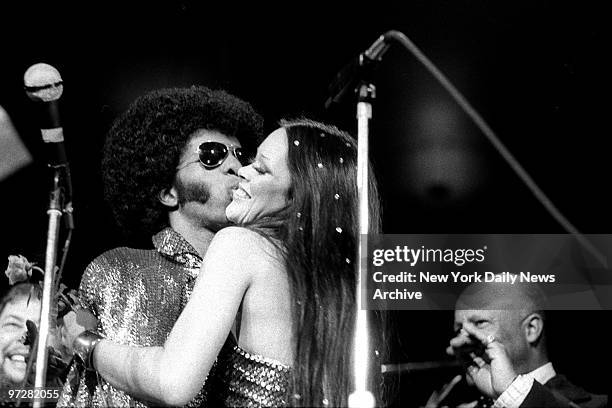 Sly Stone gets an old-fashioned hug from bride, Kathy Silva mother of the rock star's 9-month-old son, Sylvester Jr., after the couple's wedding...