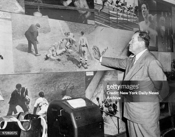 Former baseball and football player Jim Thorpe, who also won the pentathlon and decathlon in the 1912 Olympics, inspects old sports photos during a...