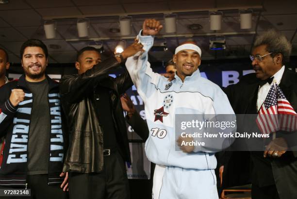 Former boxer Felix Trinidad holds up the hand of Fres Oqendo as John Ruiz and promoter Don King look on at Madison Square Garden. King announced a...