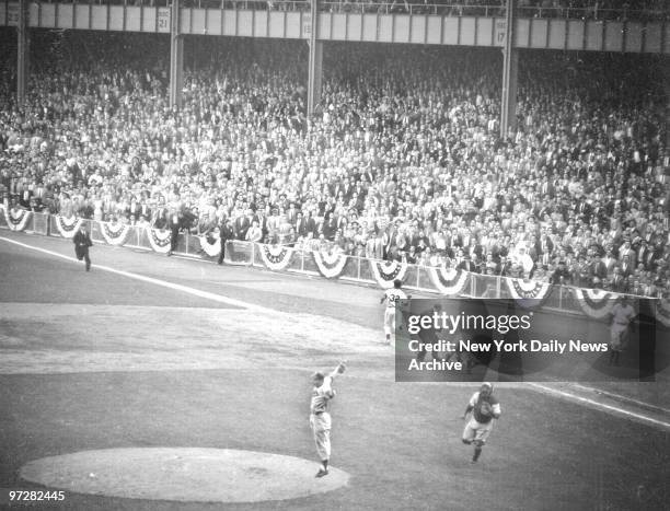 Brooklyn Dodgers players celebrate as New York Yankees' Elston Howard is retired for the last out in the Dodgers' victory over the New York Yankees...