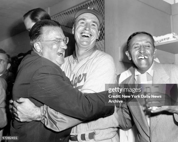 Brooklyn Dodgers president Walter O'Malley and his manager, Walter Alston, exchange hugs and grins after bringing Brooklyn its first World Series...