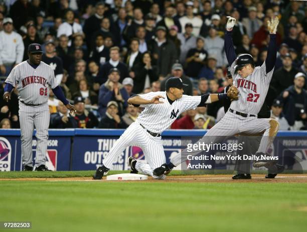New York Yankees' Alex Rodriguez tags the Minnesota Twins' Justin Morneau out at third base in the first inning of Game 2 of the American League...