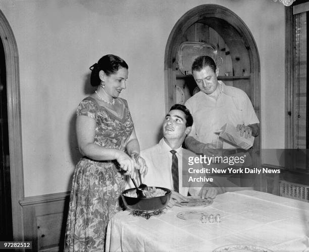 Brooklyn Dodgers' Sandy Koufax is given full treatment by his parents at home after the 19-year-old snared his first major league victory with a...