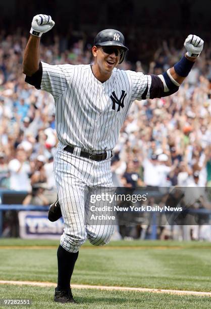 New York Yankees' Alex Rodriguez throws his fists in the air as he starts his home run trot after hitting his 500th career homer in the first inning...