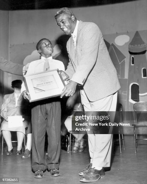 Brooklyn Dodgers Youth Council Award , Dodgers' Jackie Robinson hands scroll to Harold Townsend of PS 194, 242 W. 144th Street. Award by Youth...