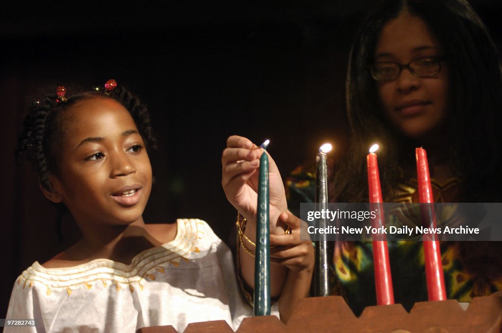 Brooklyn students light a candle celebrating Ujamaa (Coopera