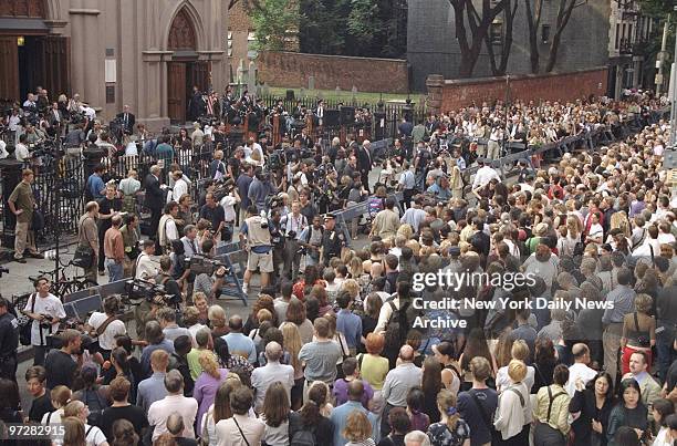 Crowd gathers outside Old St. Patrick's Cathedral during memorial service for John F. Kennedy Jr., his wife, Carolyn Bessette Kennedy, and her...