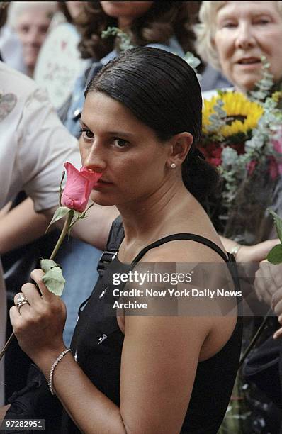 Jamie Gottschell of Jersey City, holds a single red rose outside Old St. Patrick's Cathedral during memorial service for John F. Kennedy Jr., his...