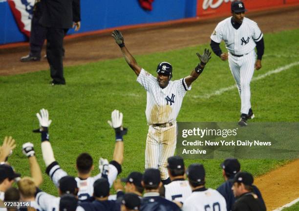 New York Yankees' Alfonso Soriano is greeted by teammates after hitting a two run homer in the ninth inning to win Game 4 of the American League...