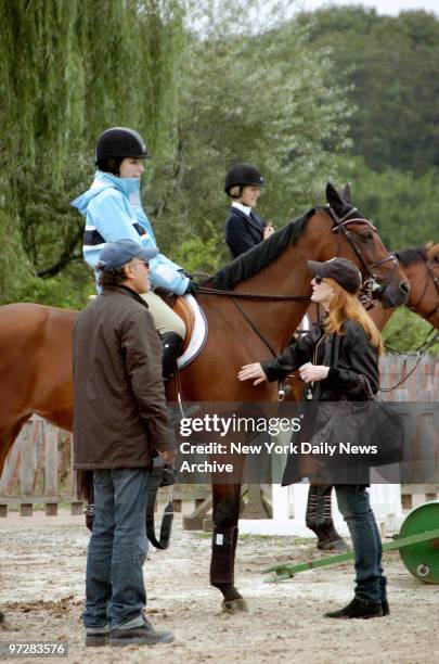 Bruce Springsteen and his wife, Patti Scialfa, talk with their daughter, Jessica, before she competes in the 31st Annual Hampton Classic Horse Show...