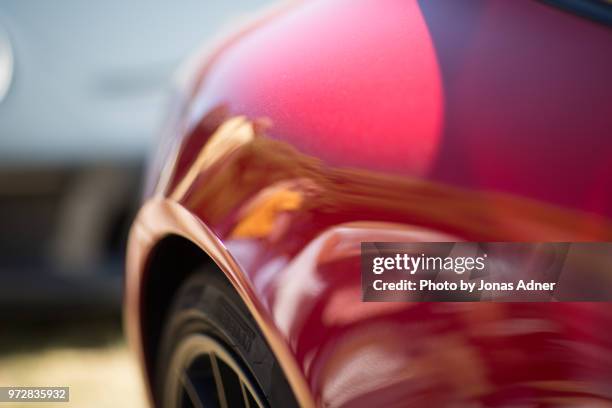 part of the front of a red car - jonas adner stock pictures, royalty-free photos & images