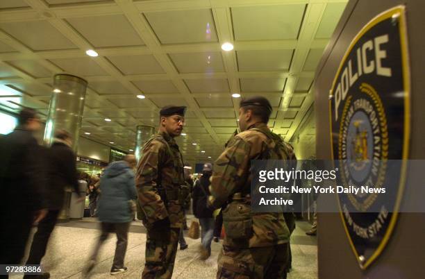 National Guard troops stand watch at Penn Station after the Bush administration today raised the national terror alert from yellow to orange, the...