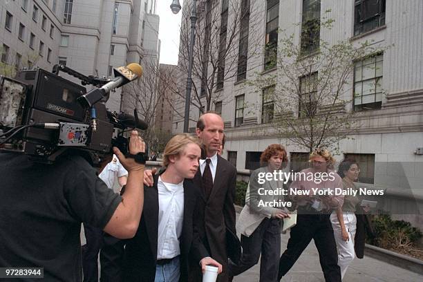 Macaulay Culkin leaves civil courthouse with unidentified man who acted as bodyguard for the child actor from the media.