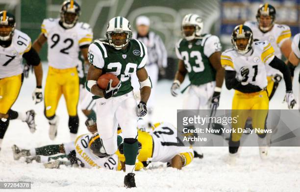 The New York Jets' Curtis Martin leaves a field of Pittsburgh Steeler defenders trudging through the snow behind him as he runs for yardage in the...