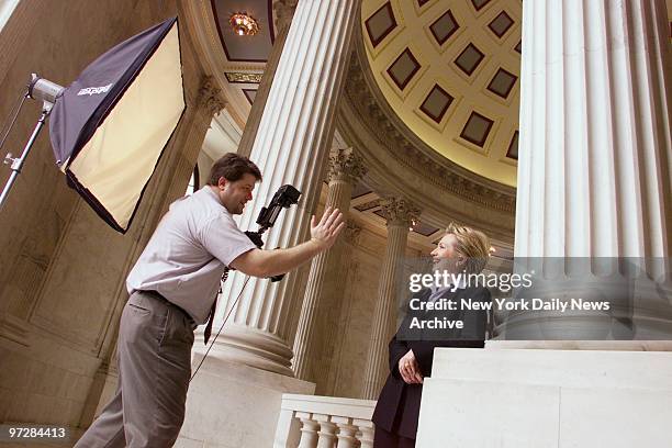 Sen. Hillary Rodham Clinton follows photographer Jeff McEvoy's directions as she has her official portrait taken in the rotunda of the Russell Senate...