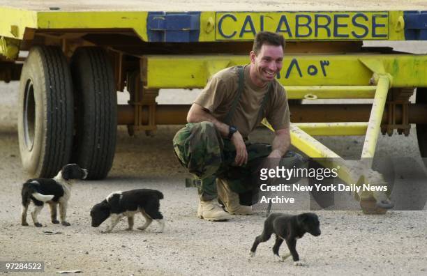 Navy Seabee Mark Calabrese gets acquainted with some of the newer residents of Umm Qasr. Meanwhile, the British army, in an effort to rebuild the...