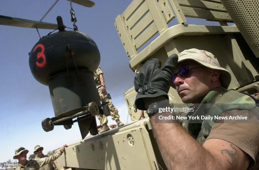 Navy Seabee Mike Midonia, 41, of Forked River, N.J., guides