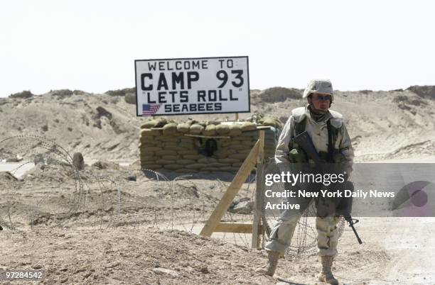 Navy Seabee stands guard at Camp 93 in the Kuwaiti desert, which is named after United Airlines Flight 93, hijacked on Sept. 11. The base has as its...