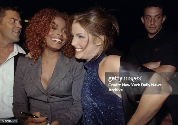 Janet Jackson and Lisa Marie Presley enjoy a few laughs during a record listening party of Jackson's new album.,
