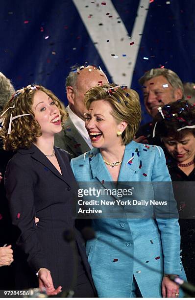 Senator-elect Hillary Rodham Clinton shares a laugh with daughter Chelsea as the two are showered with confetti during victory celebration at the...
