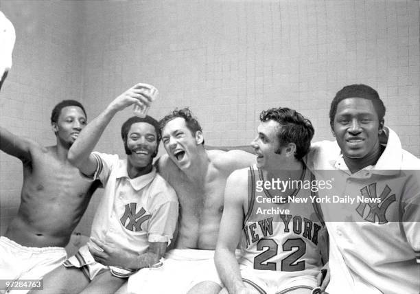 The New York Knicks' starting five -- Dick Barnett, Walt Frasier, Bill Bradley, Dave DeBusschere, and Willis Reed -- rejoice in the dressing room...