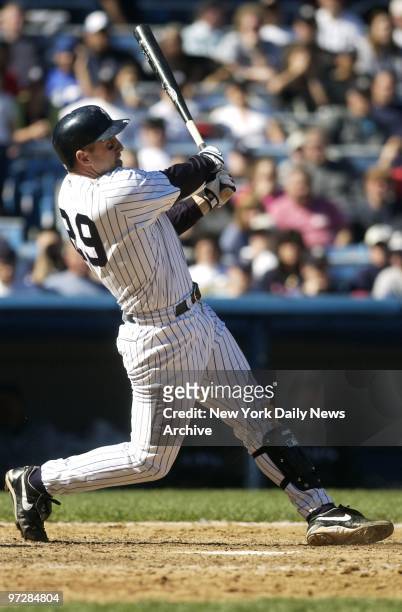 New York Yankees' Bubba Trammell slugs a ball which bounces off the glove of Tampa Bay Devil Rays' outfielder Carl Crawford in the eighth inning of...