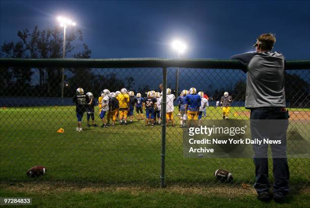 Spectator watches members of the Bay-Waveland Youth Football League Gold Tigers and Lightning Quick Blue Tigers practice on their newly-repaired...