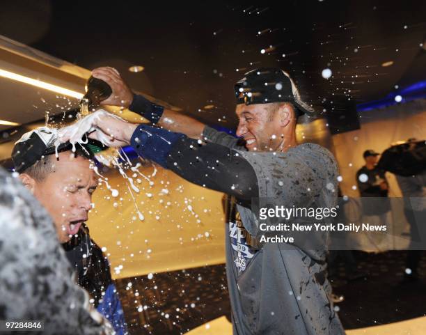 New York Yankees captain Derek jeter douses A-Rod with champagne after the Bronx Bombers clinched the AL East championship with a three-game sweep of...