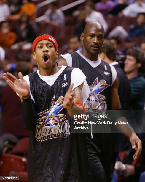 All-Star East team's Allan Iverson of the Philadelphia 76ers cheers a three-point shot as teammate Michael Jordan of the Washington Wizards looks on...