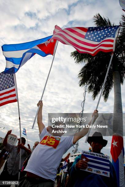 Cuban-Americans fly Cuban and American flags as they gather in the Little Havana section of Miami, Fla., to celebrate the news that Fidel Castro has...