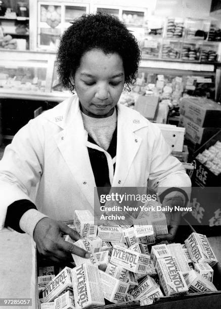 Janie Sinclair looks over boxes containing Tylenol after they were removed from shelf at Sloan's.