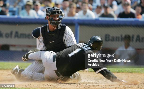 New York Yankees' catcher Jorge Posada blocks the plate to prevent Chicago White Sox's Danny Richar from scoring in the seventh inning of a game at...