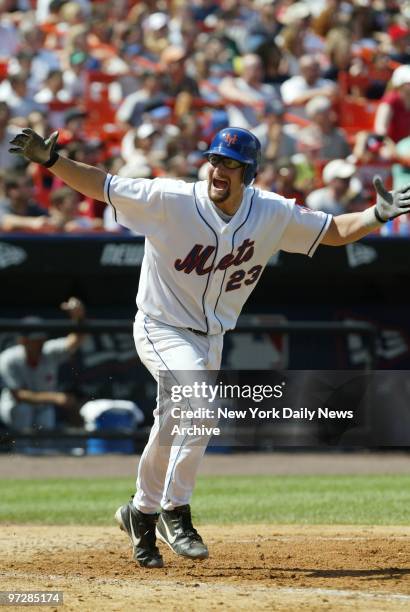 The New York Mets' Jason Phillips gleefully heads for first after hitting an RBI single in the four-run seventh inning against the St. Louis...