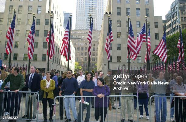 Curious tourists and New Yorkers alike gather near NBC office at 30 Rockefeller Center, the site of the latest case of anthrax. A personal assistant...