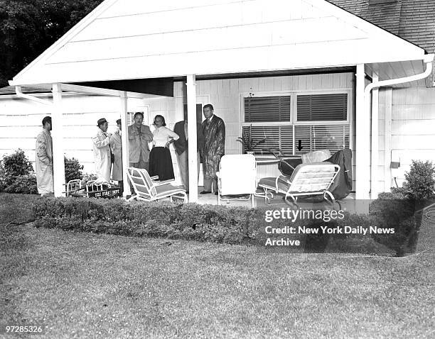 Neighbors and detectives gather on patio of the Weinberger home at 17 Albemarle Road in Westbury, scene of kidnaping. The infant was taken from...