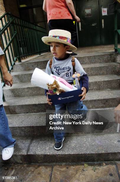 Bryan Vasquez carries his box of belongings home after cleaning out his desk on the last day of classes at Public School 58 in Carroll Gardens,...