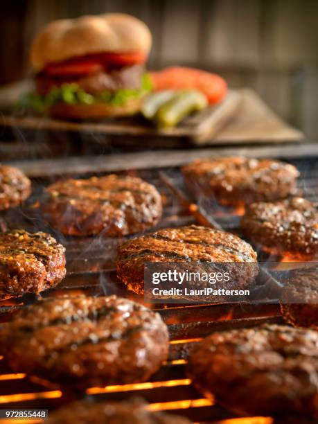 hamburgers on the bbq - hamburger stock pictures, royalty-free photos & images