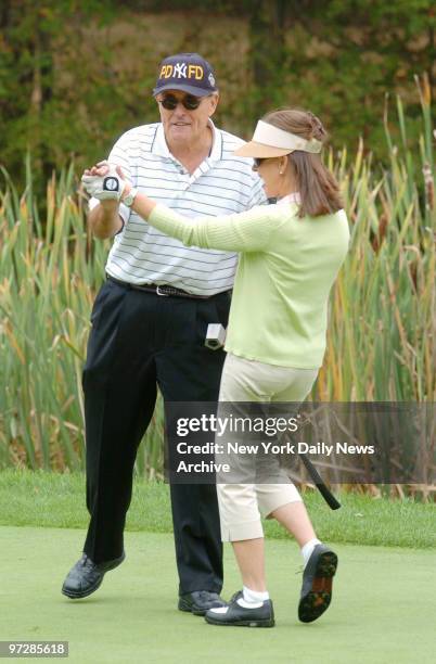 Former Mayor Rudolph Giuliani and wife Judith hit the green at the Trump National Golf Course in Westchester, where they co-hosted a golf outing to...