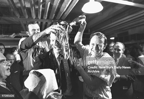 Bubbling over with excitement, Jerry Grote [left] and Rod Gaspar give Mayor John Lindsay a bath in champagne in wild clubhouse celebration at Shea...