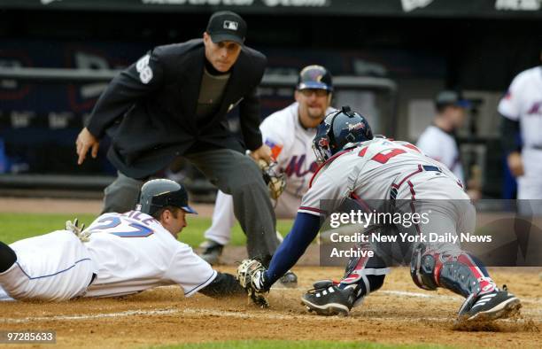 The New York Mets' Todd Zeile makes a head-first slide to home plate to score in the fourth as Atlanta Braves' catcher Johnny Estrada is late with...